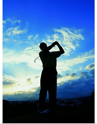 silhouette of a golfer after a swing