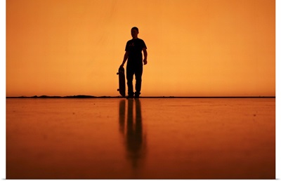 Silhouette of man with skateboard, Berlin.