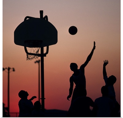 Silhouette of men playing basketball