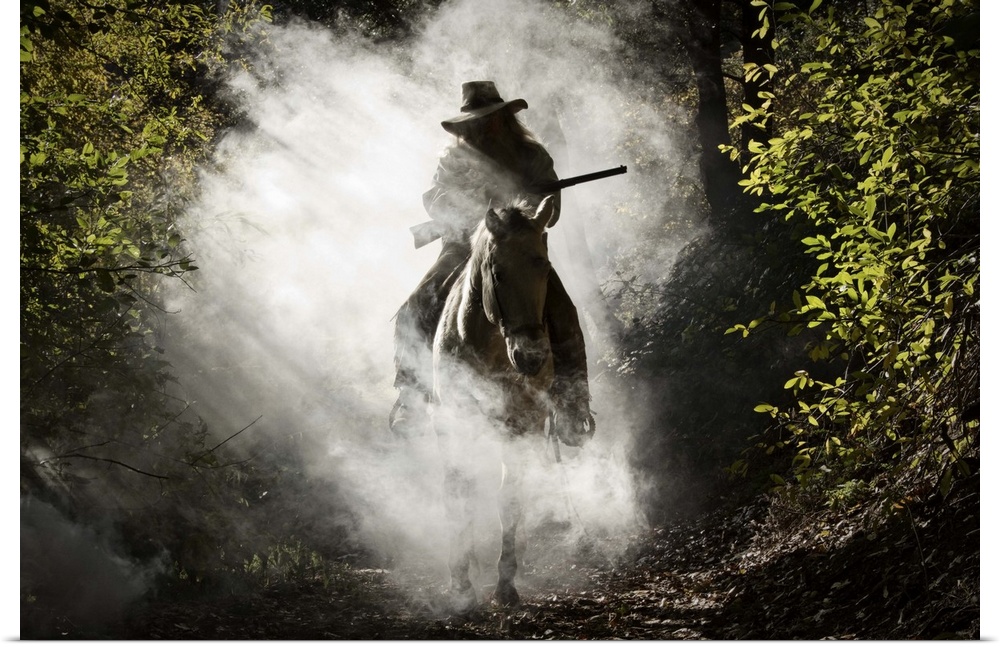 Bounty hunter, rider on the horse covered with smoke holding a gun