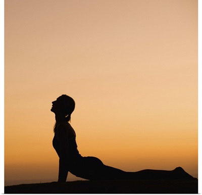 Silhouette of woman doing yoga