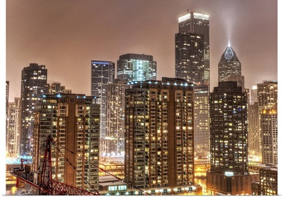 Snow falls over skyline at evening in Chicago.