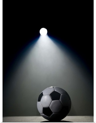 Soccer ball in spotlight