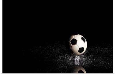 Soccer ball on black reflective surface