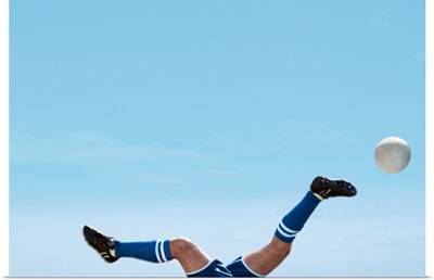 Soccer Player Upside-Down Attempting To Kick The Ball