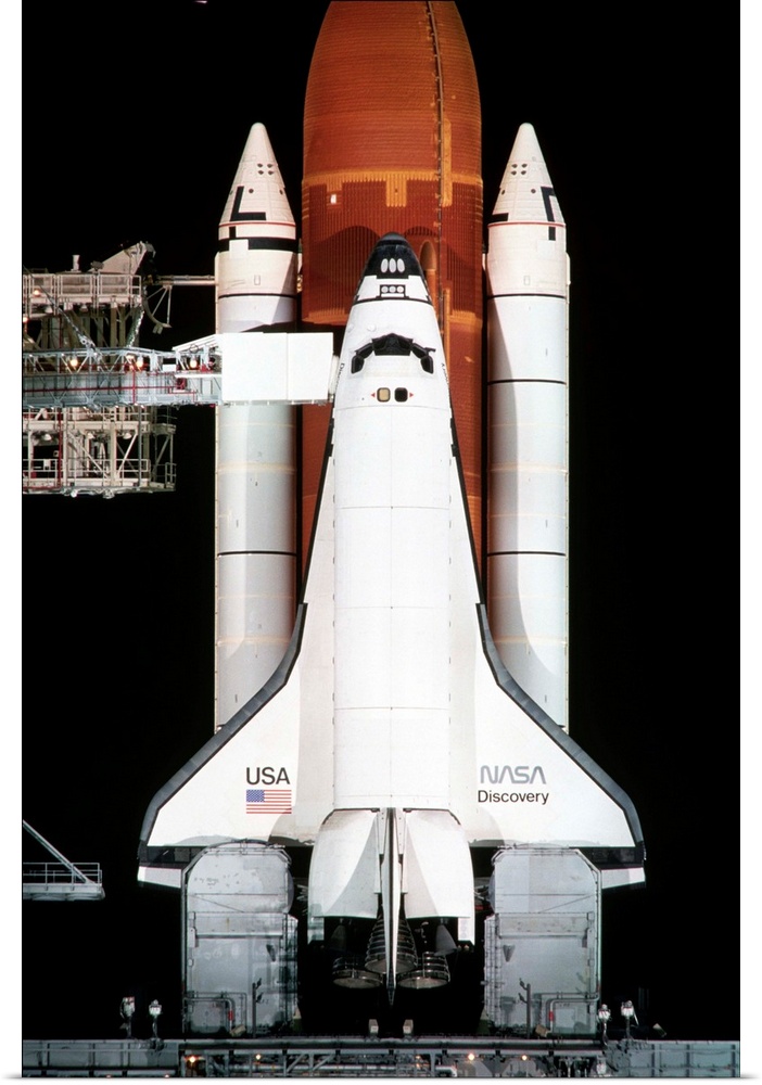 The space shuttle Discovery sits on the launch pad on the eve of the launch of Space Shuttle Mission 26.