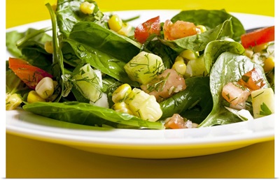 Spinach and sweet corn salad with tomatoes, cucumber and dill
