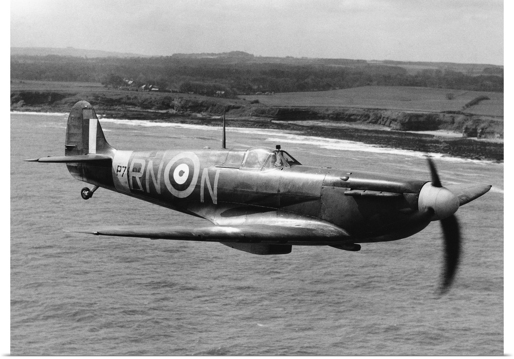 A Spitfire in flight of the coast of Britain during World War II.