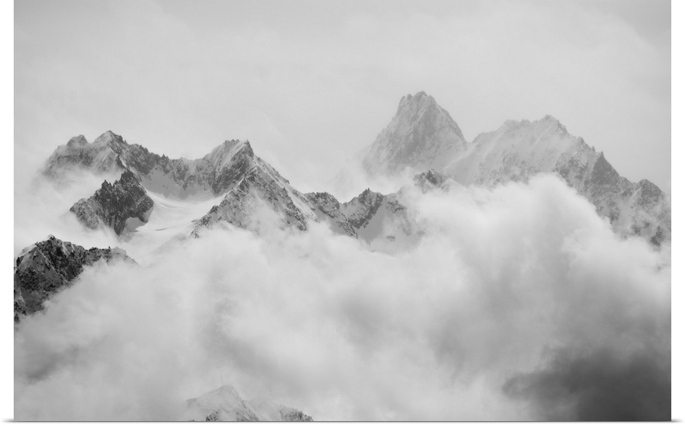 Atmospheric clouds linger around the peaks of the Swiss alps after a spring snow storm.