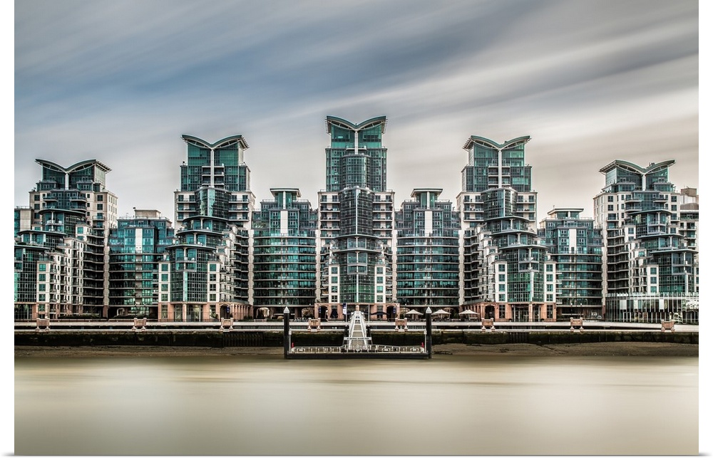 Long exposure of the five ultra modern towers of Saint Georges Wharf, with the rives Thames in the foreground and dramatic...