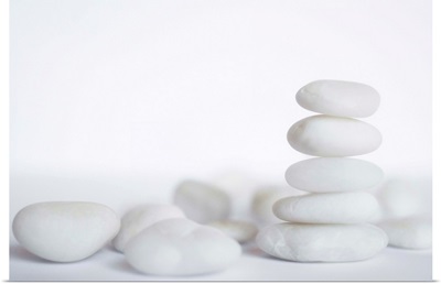 Stack of white pebbles on white background.