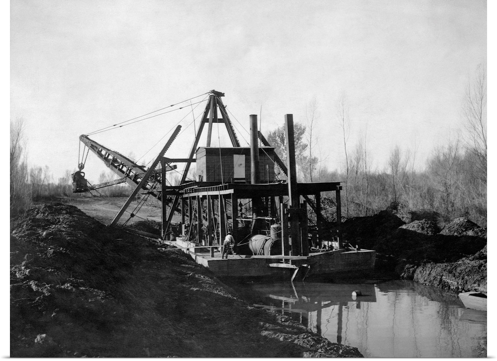 a Steam powered hydraulic dredge cut a canal through rural marsh land.