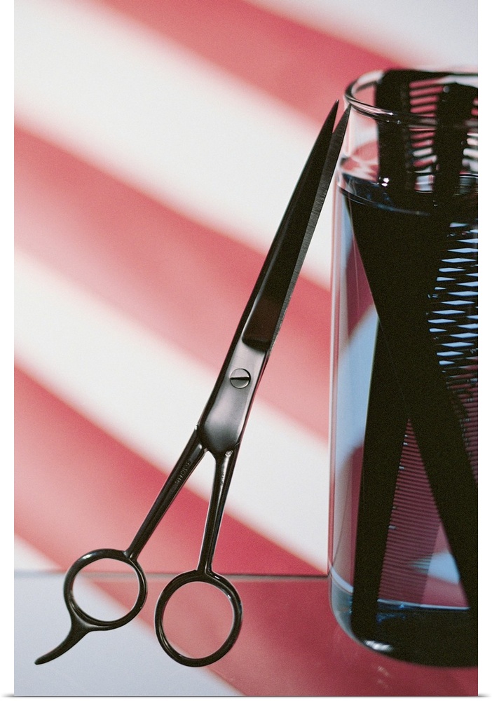 Still life of barbershop pole with scissors and combs