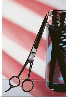 Still life of barbershop pole with scissors and combs