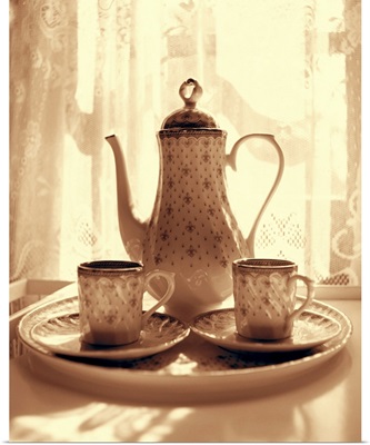 Still life of teapot and cups on tray by window