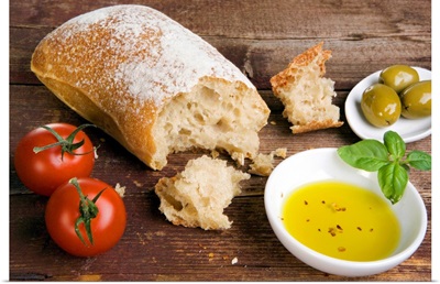 Still life with ciabatta, olive oil, olives and tomatoes