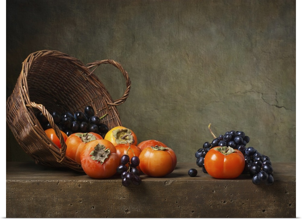 Still life with persimmons and grapes on the table.