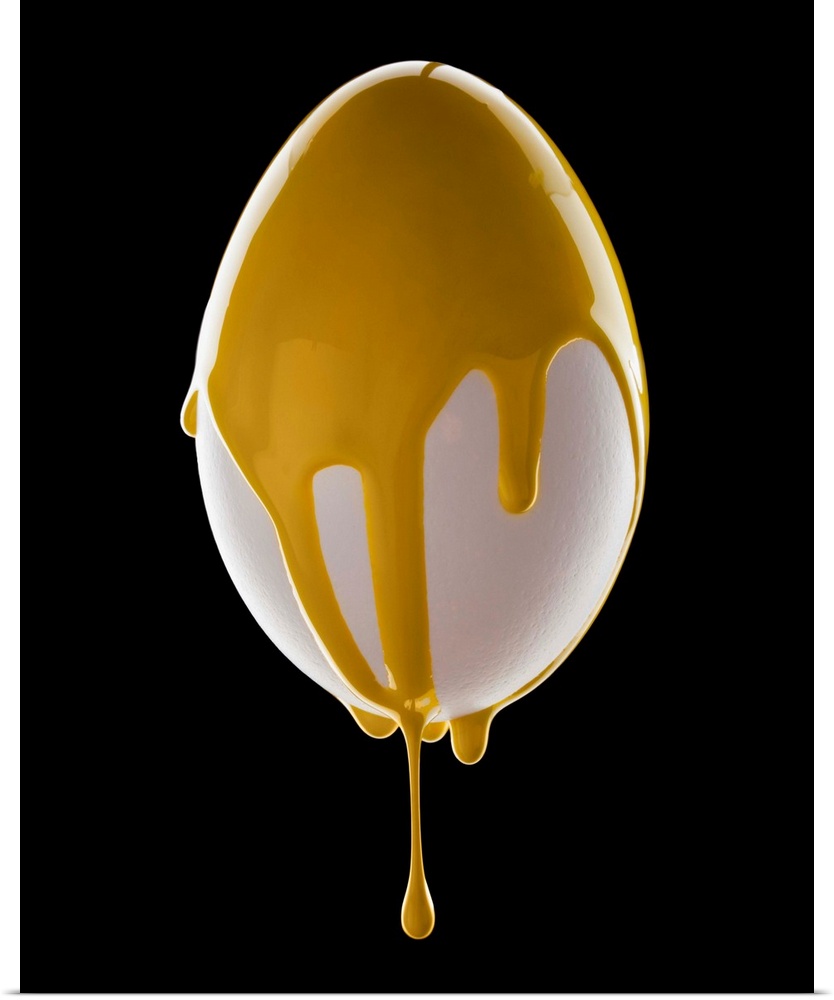 Studio shot of egg covered with yellow paint