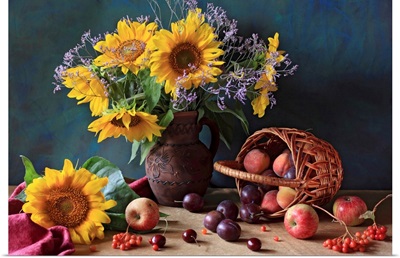 Summer still life with sunflowers, apples, peaches, plums, rowan berries and cherries