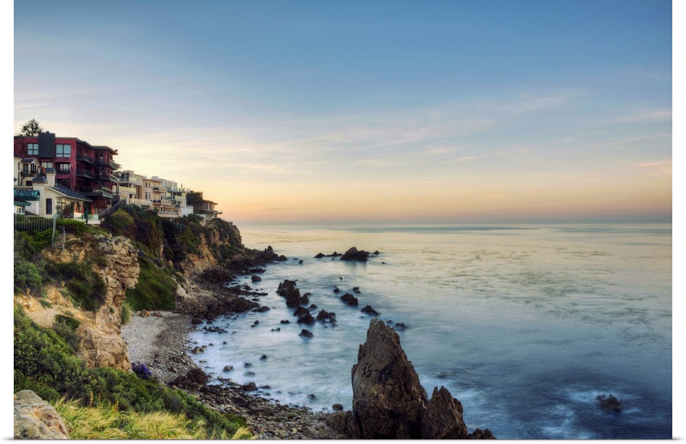 Sunrise over cove in Corona Del Mar, California and into  windows of these ocean-view mansions.  Perched on bluff, few Cal...