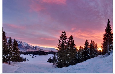 Sunset over snowy forest in French Alps near Grenoble.