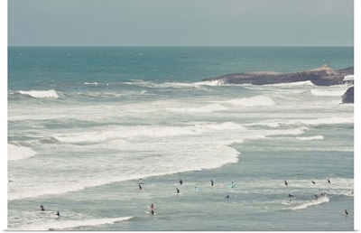 Surfers lying in ocean.