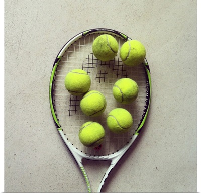 Tennis racquet and tennis balls.