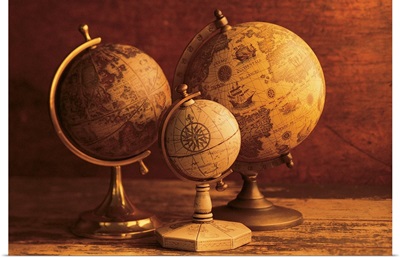 Three globes with world map backdrop