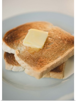 Toasts with butter on plate