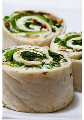 Tortilla rolls filled with goat's cheese and salad, close-up
