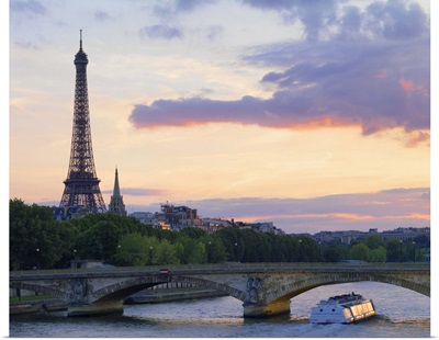 Tour boat on the River Seine near the Eiffel Tower at dusk