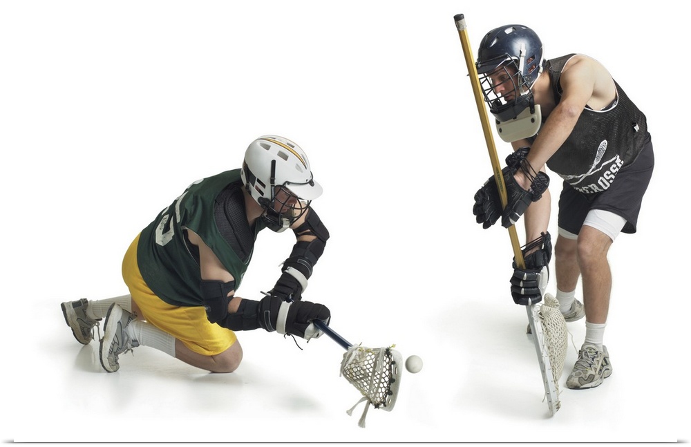 two caucasian male lacrosse players from opposing teams confront each other as one steals a pass from the other