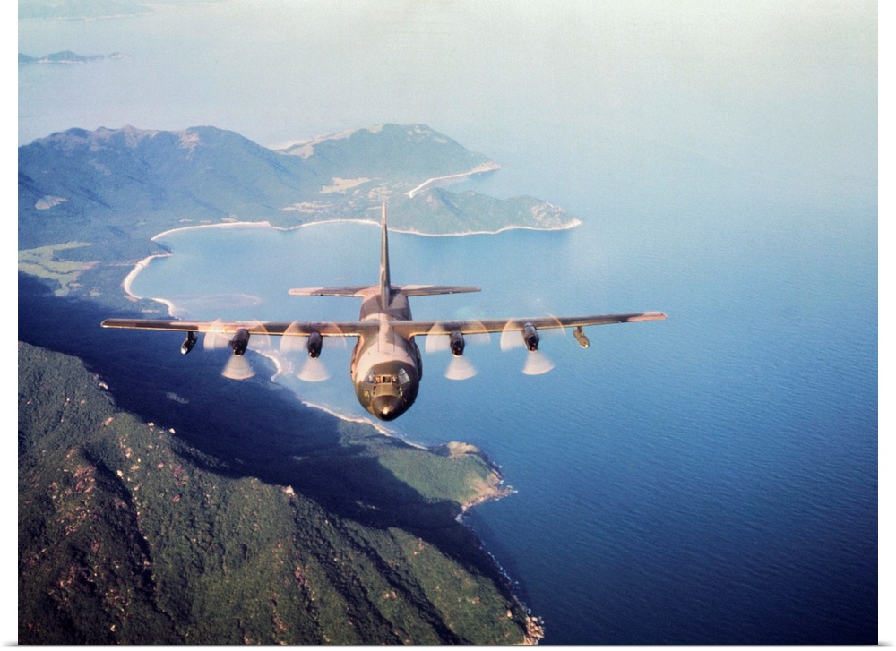Vietnam. a U.S. Airforce c-130 Hercules flies along the South Vietnamese coast on a cargo and passenger mission in support...