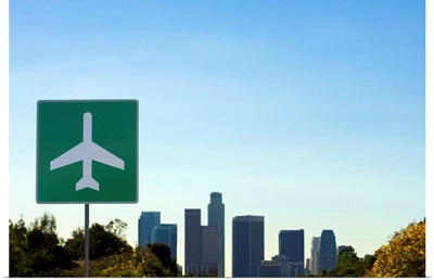 USA, California, Los Angeles, airport sign with city skyline in background