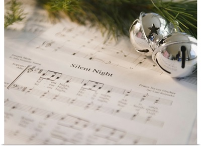USA, New Jersey, Jersey City, Christmas baubles on carol music sheet