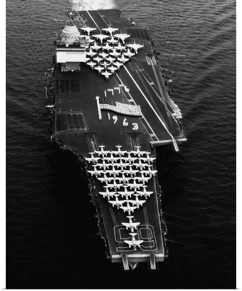 Navy crewmen form an image of the national ensign on the flight deck of the new USS Enterprise aircraft carrier.