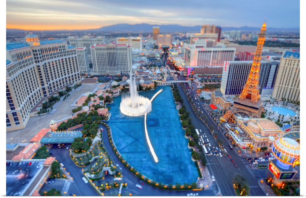 Rooftop shot of the Las Vegas strip at sunset with the Bellagio fountain.