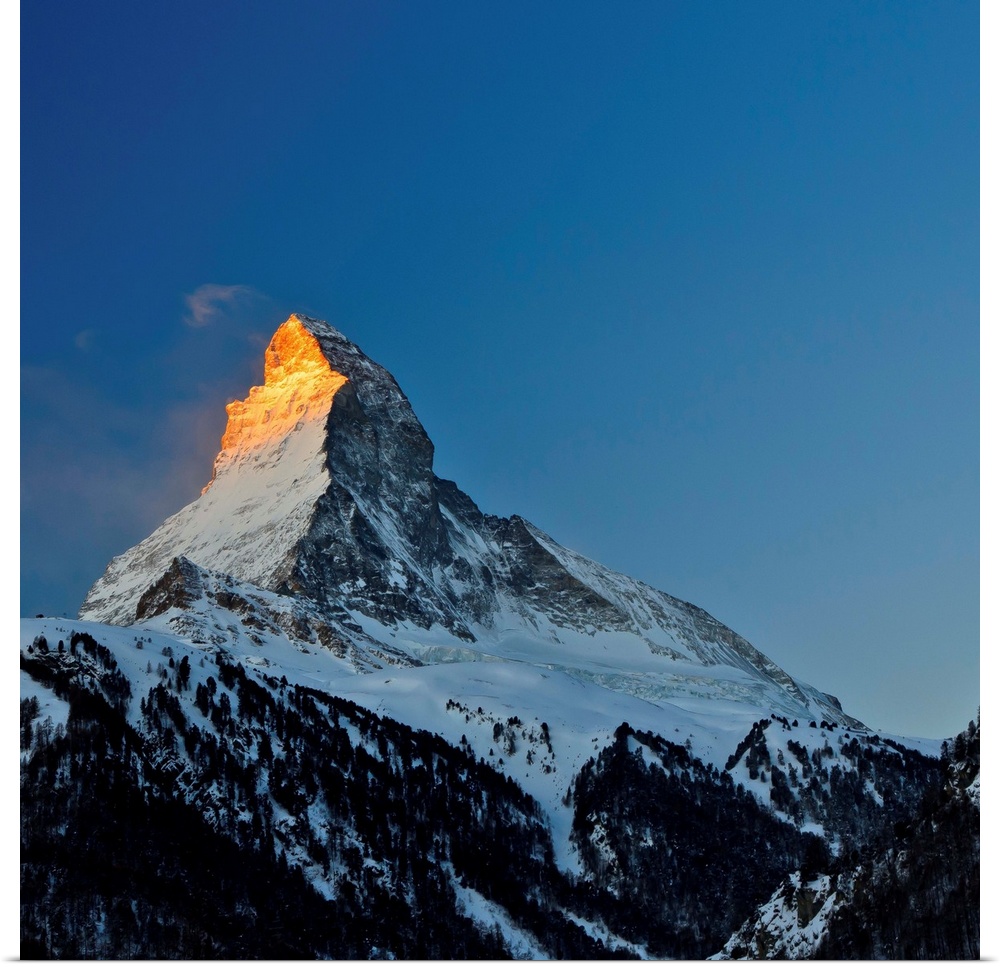 View of Matterhorn, Alpes, in sunrise, blue sky in background.