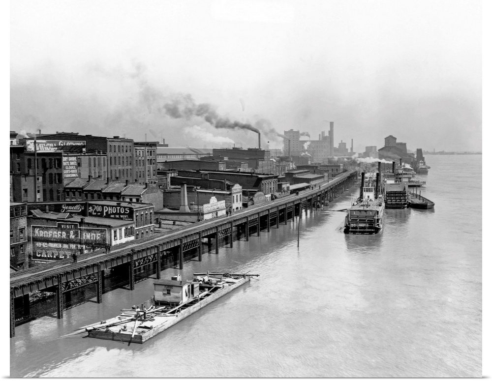 Boats move down the high water of the Mississippi River in 1892, next to the waterfront.