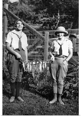 Vintage image of women holding string of fish