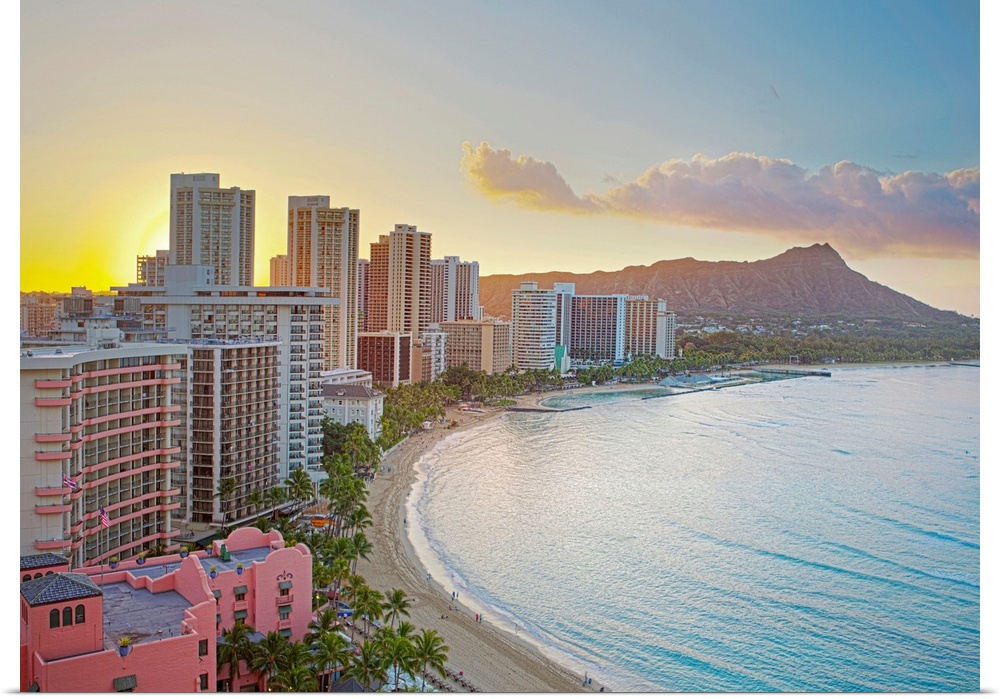 Landscape photograph on a large wall hanging of the sun rising over buildings along Waikiki Beach, Diamond Head Crater in ...