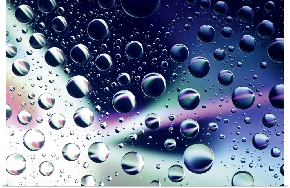 Horizontal close up photograph on a giant wall hanging of many water droplets sitting on a clear surface, with swirls of v...