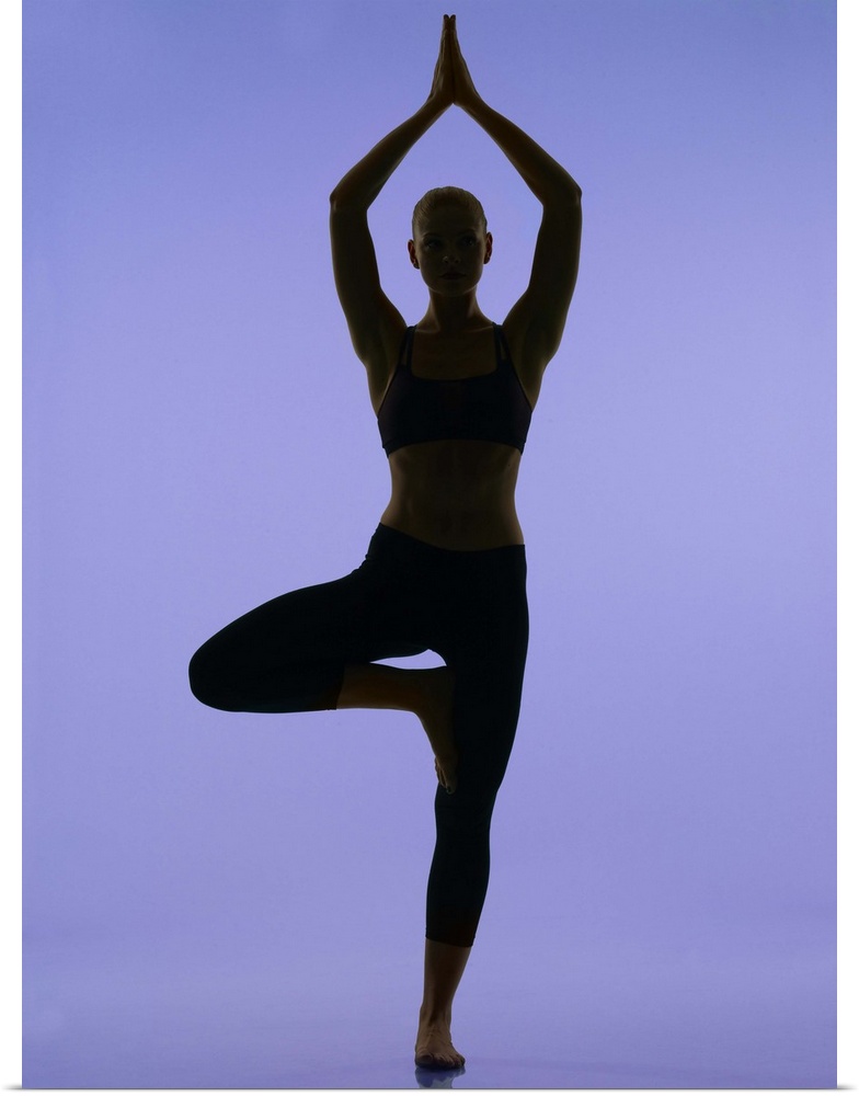 girl doing yoga stretches in silouette on purple background