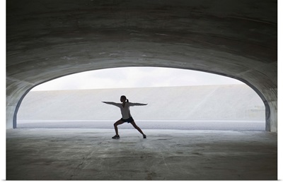 Woman stretching in tunnel