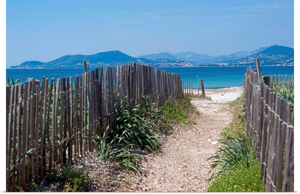 Wooden fences (ganivelles) on both sides of the pathway that leads to the Almanarre Beach in Hyres. Sea and mediterranean ...