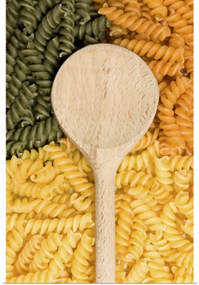 Wooden spoon, green and yellow noodles