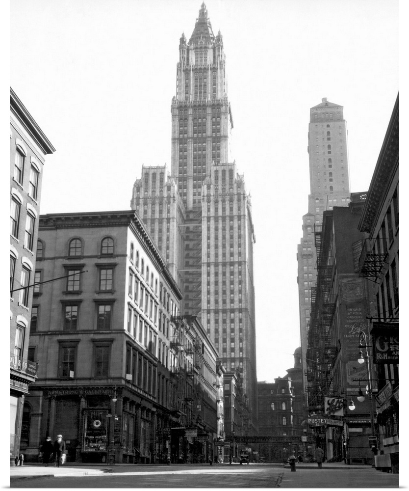 Black and white photograph of a skyscraper in New York City that towers over others surrounding it.