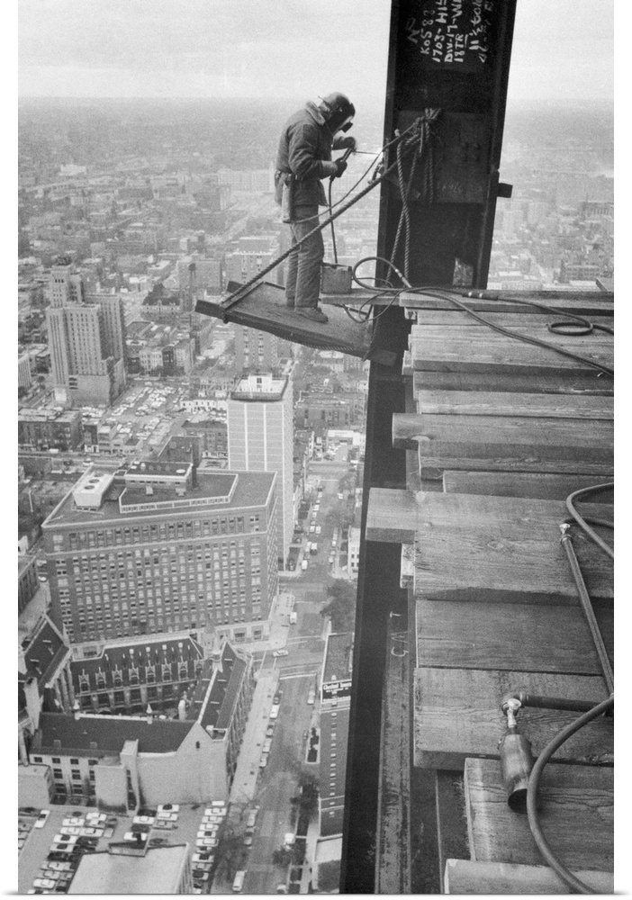 High Up. Chicago, Illinois: High above Chicago, Charles White has a job that few persons would want, as he welds steel bea...