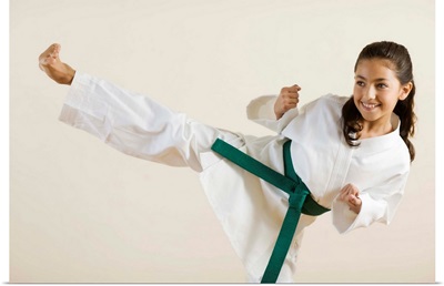 Young girl doing karate kick