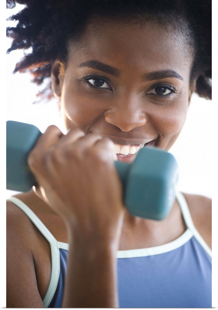 Black woman exercising with hand weights